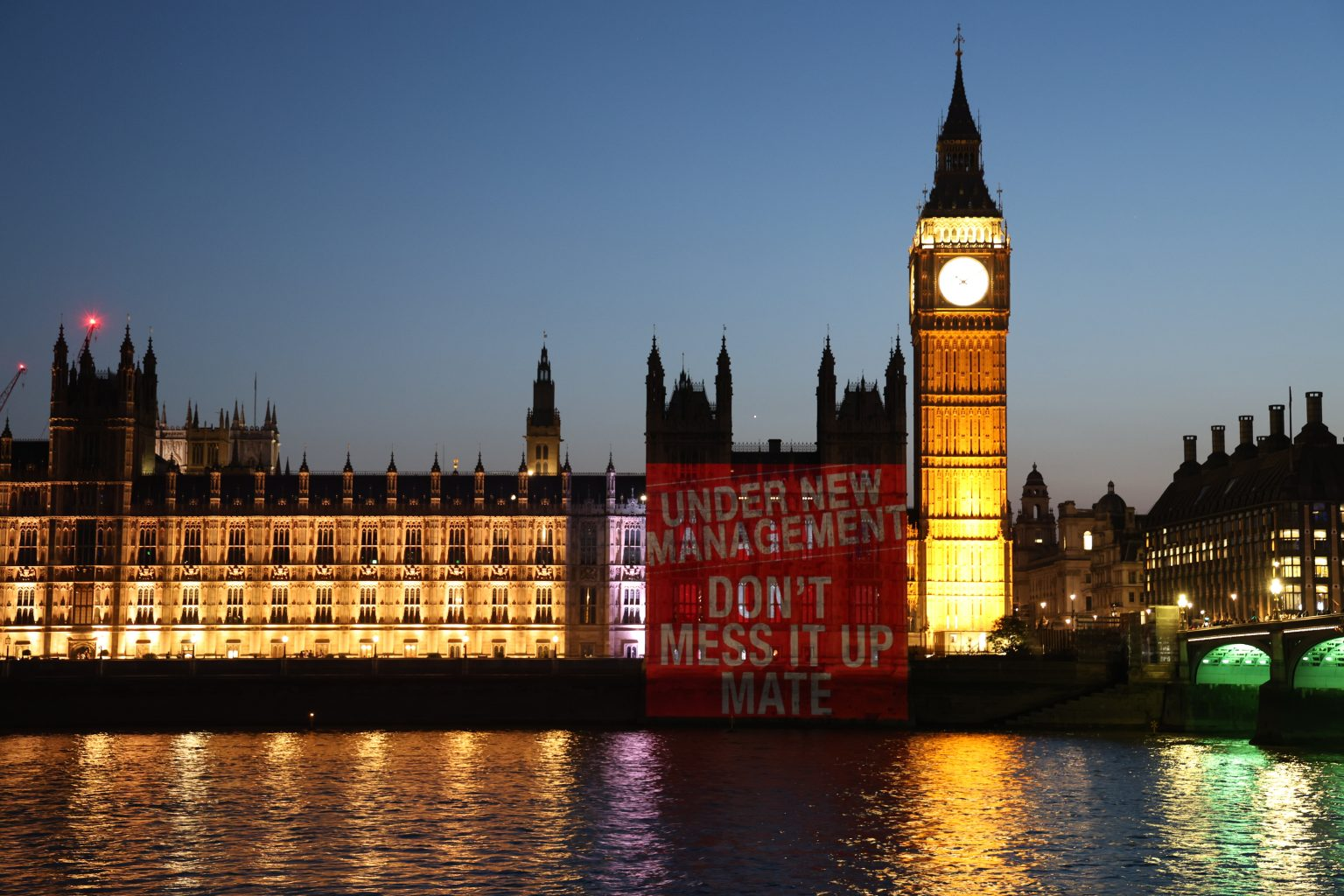 Projection on Parliament telling new PM Andy Burnham not to mess it up.
